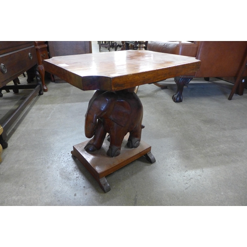 223 - An African carved hardwood elephant based occasional table