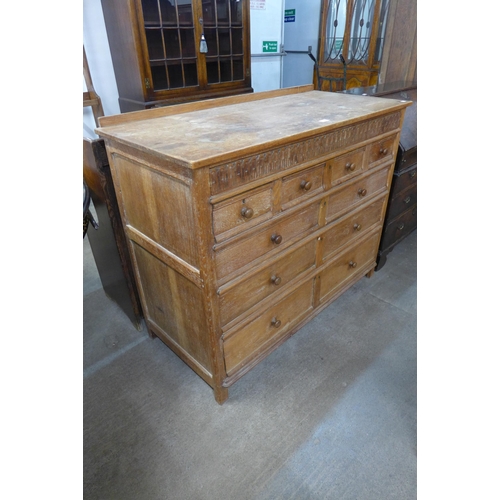 294 - A Heals style oak geometric moulded chest of drawers