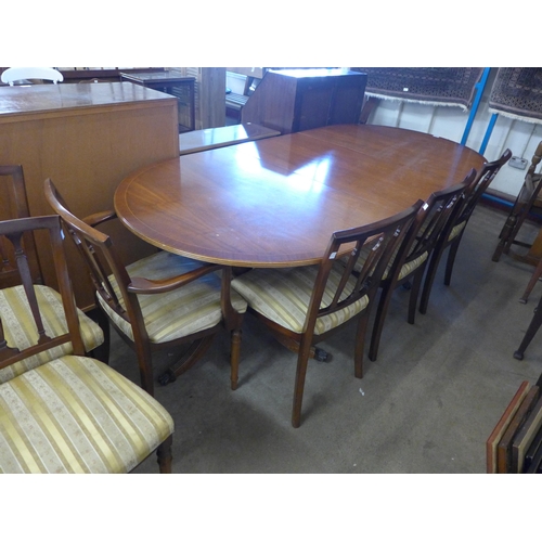 304 - A Regency style inlaid mahogany 10 piece dining suite comprising of pedestal dining table, eight cha... 