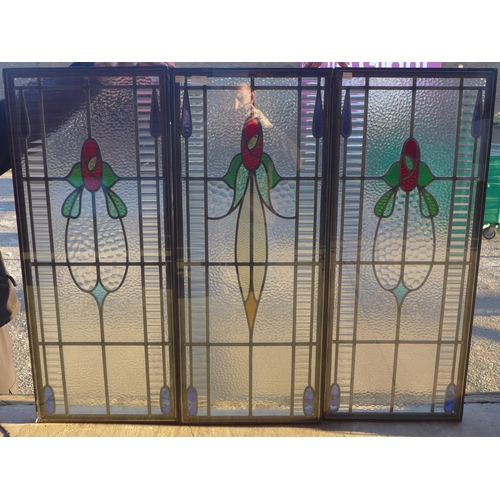 315 - A set of three Art Nouveau style stained glass windows and another three