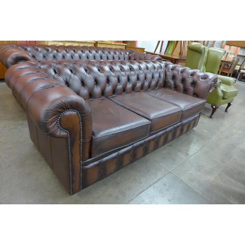 58 - A chestnut brown leather Chesterfield settee, 73cms h, 204cms w, 88cms d