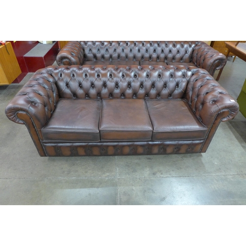 58 - A chestnut brown leather Chesterfield settee, 73cms h, 204cms w, 88cms d