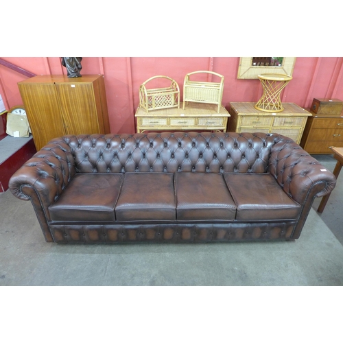 59 - A chestnut brown leather Chesterfield settee, 73cms h, 248cms w, 88cms d