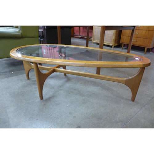 60 - A Stonehill Stateroom teak and glass topped tear shaped coffee table