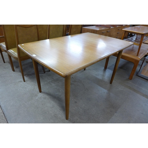 89 - A teak extending dining table