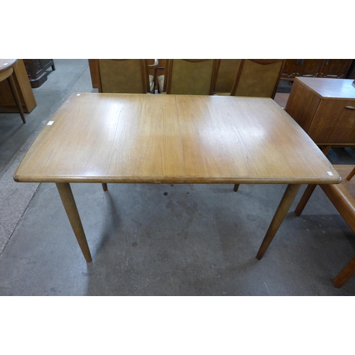 89 - A teak extending dining table