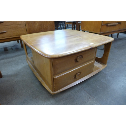 94 - An Ercol Blonde elm Pandora's Box coffee table