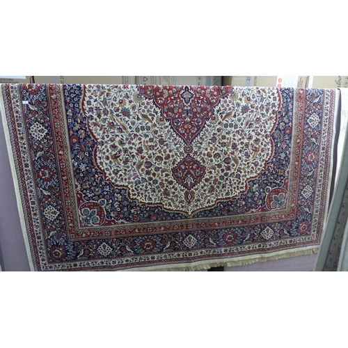 1539 - A large ivory ground Cashmere carpet with floral medallion design, 280cm x 380cm