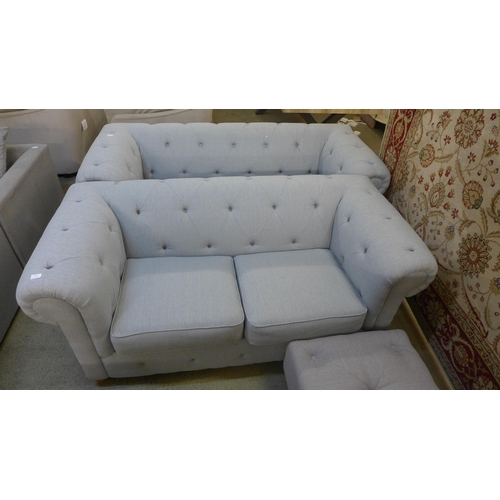 1542 - A grey upholstered Chesterfield three seater, two seater and a footstool