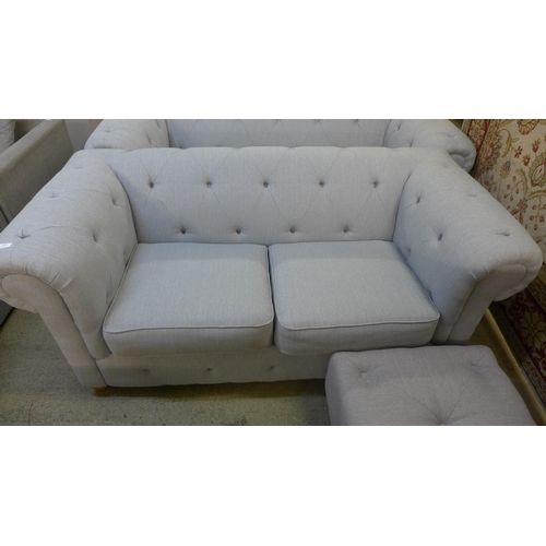 1542 - A grey upholstered Chesterfield three seater, two seater and a footstool