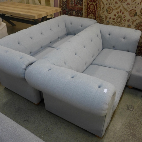 1542 - A grey upholstered Chesterfield three seater, two seater and a footstool