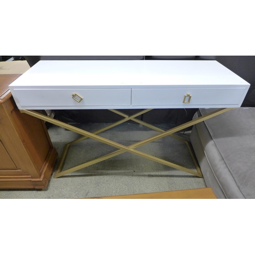 1565 - A white painted two drawer console on gold cross legs