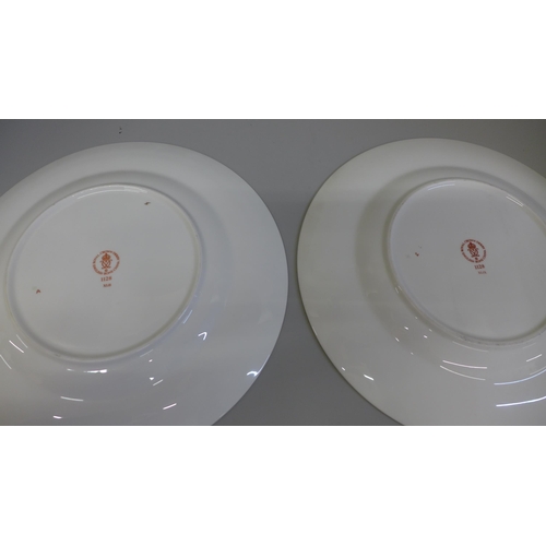 602 - A pair of Royal Crown Derby 1128 pattern dinner plates, 27cm