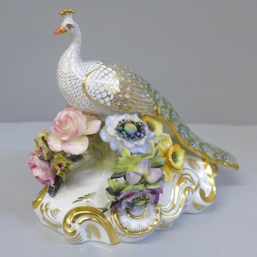 605 - A Royal Crown Derby peacock figure, J. Griffiths, J. Plant