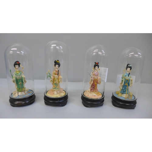 627 - Four small oriental Four Seasons figures under glass domes, 9cm