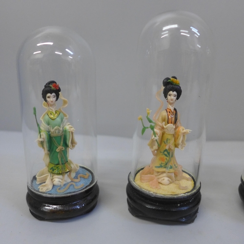 627 - Four small oriental Four Seasons figures under glass domes, 9cm