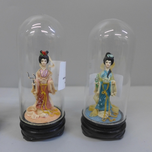 627 - Four small oriental Four Seasons figures under glass domes, 9cm