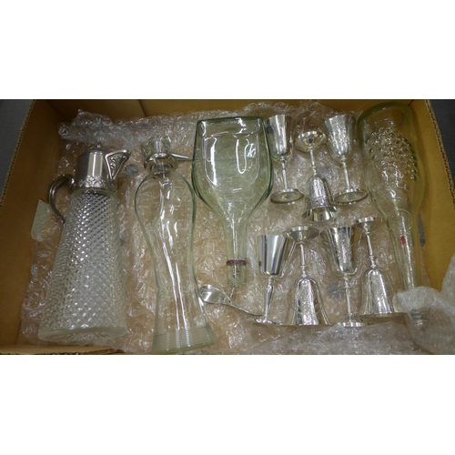 704 - A collection of silver plated cups, claret jug, decanters, etc.