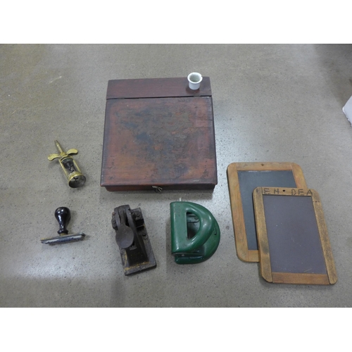 796 - A desk seal, brass corkscrew, hole punch, writing desk and two chalk slates