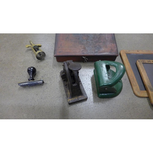 796 - A desk seal, brass corkscrew, hole punch, writing desk and two chalk slates