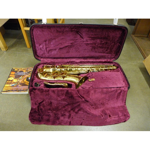 801 - A cased saxophone, marked AK, with instruction booklet