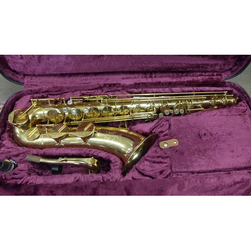 801 - A cased saxophone, marked AK, with instruction booklet