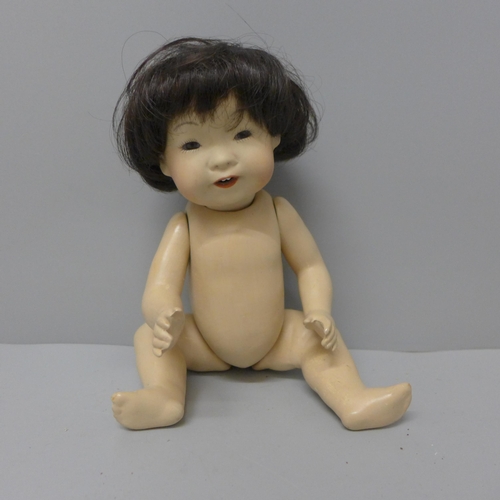 810 - A doll, marked JDK, 243, 26cm