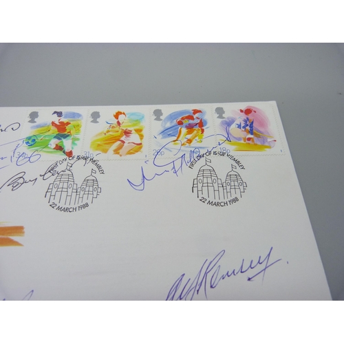 818 - A 1988 Royal Mail First Day Cover with six World Cup 1966 winners autographs, Alf Ramsey, Bobby Moor... 