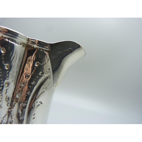 821 - An embossed silver jug, George Unite, Birmingham 1864, 99g, height 8cm