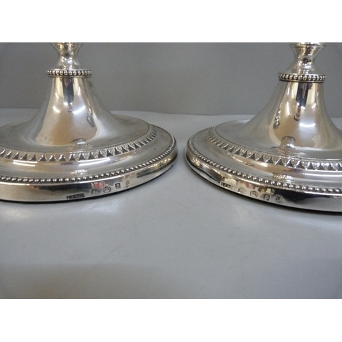 828 - A pair of George III silver candlesticks, Sheffield 1785, John Parsons & Co., 28cm