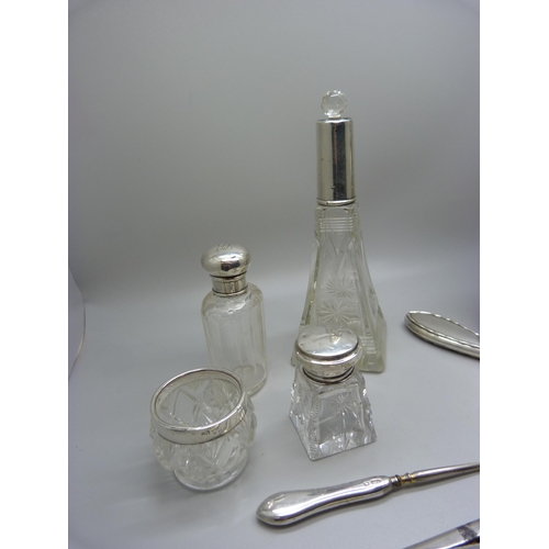 829 - A silver photograph frame, a/f, silver mounted bottles, glove stretchers, etc.