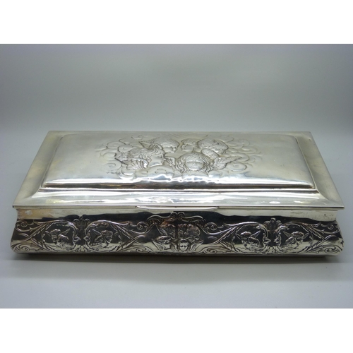 831 - A large silver jewellery box, decorated with Reynold's angels, Birmingham 1904, lid 28.5cm wide