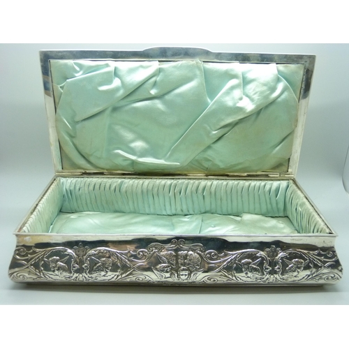 831 - A large silver jewellery box, decorated with Reynold's angels, Birmingham 1904, lid 28.5cm wide