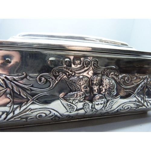 831 - A large silver jewellery box, decorated with Reynold's angels, Birmingham 1904, lid 28.5cm wide