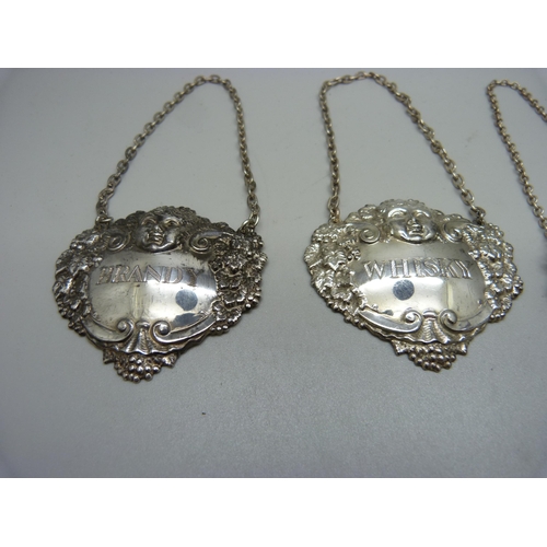 849 - A pair of hallmarked silver wine labels, one other hallmarked silver label, Port, and a Brandy label... 