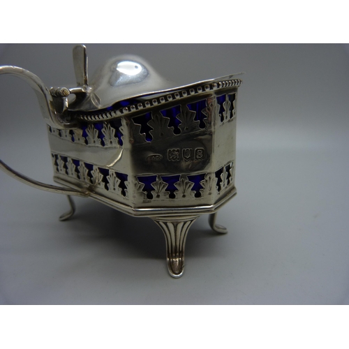 854 - A large hallmarked silver mustard, London 1913, 98g, and a matching plated salt, with blue glass lin... 