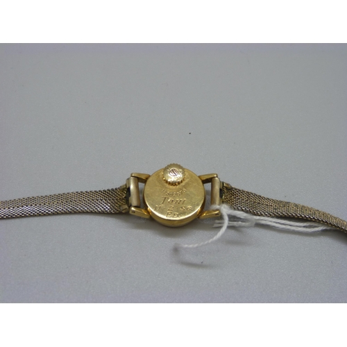 890 - A lady's 18ct gold cased Omega wristwatch with back wind, the case back bears inscription dated 1956