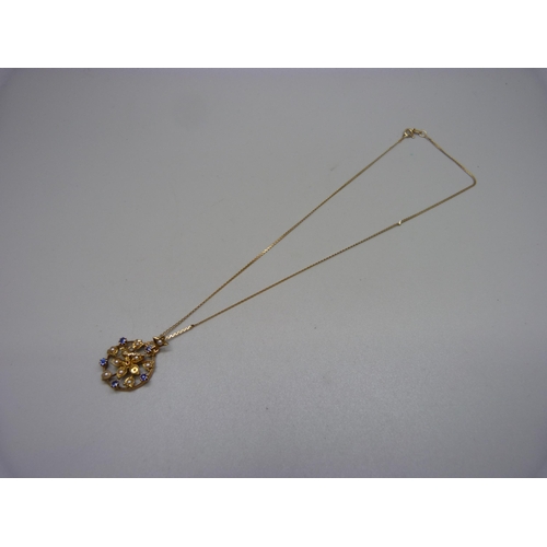 916 - A 15ct gold, seed pearl and sapphire pendant, 2.4g, on a 9ct gold chain, 1.2g, lacking one pearl