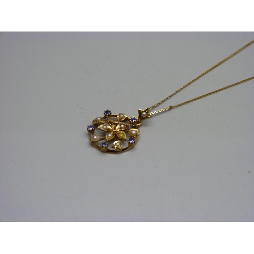 916 - A 15ct gold, seed pearl and sapphire pendant, 2.4g, on a 9ct gold chain, 1.2g, lacking one pearl