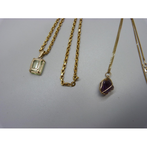 945 - A 9ct gold and green stone pendant on a 9ct gold chain, and an amethyst pendant on a 9ct gold chain,... 