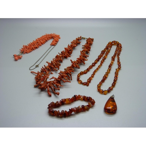 948 - Two coral necklaces, a pair of coral earrings, an amber necklace and pendant