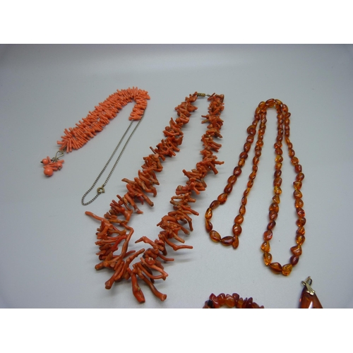 948 - Two coral necklaces, a pair of coral earrings, an amber necklace and pendant