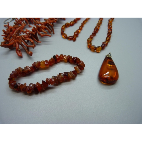 948 - Two coral necklaces, a pair of coral earrings, an amber necklace and pendant