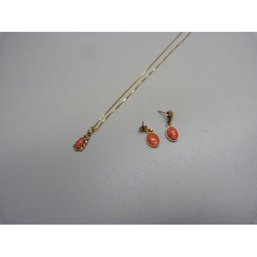 974 - A 9ct gold and coral pendant and a pair of similar earrings, 2.3g