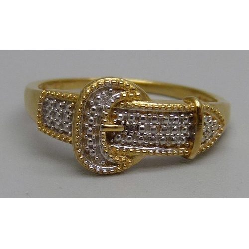 996 - A silver gilt buckle ring with a diamond accent, P