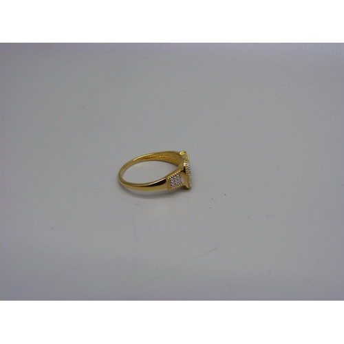 996 - A silver gilt buckle ring with a diamond accent, P