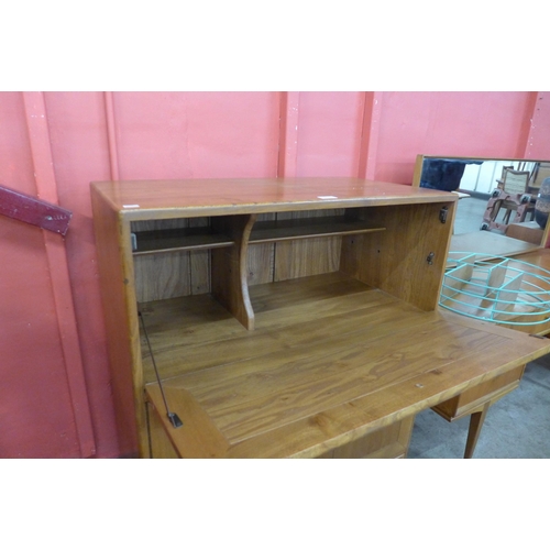 10 - An Ercol Blonde elm and beech Windsor writing cabinet