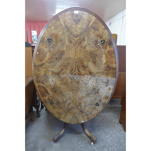 136 - A Victorian inlaid figured walnut oval tilt-top loo table