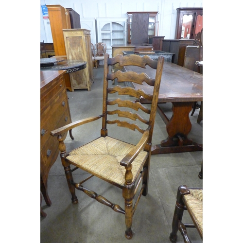 162 - A set of eight George III style beech rush seated ladderback dining chairs