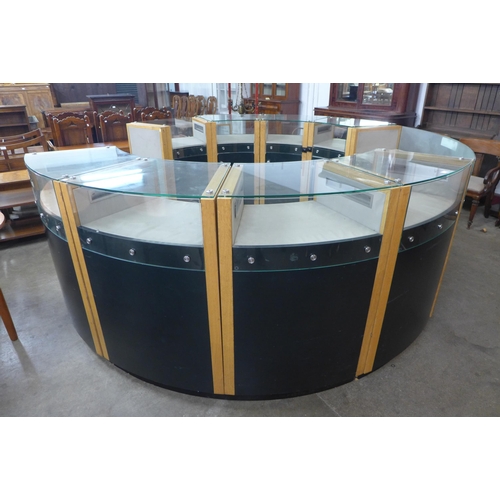 219 - A large circular glazed oak and black glass shop showroom counter